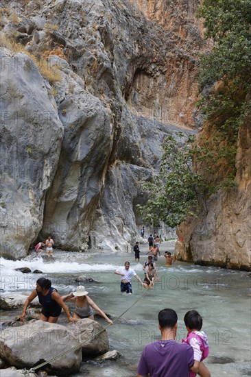 Tourists crossing the river