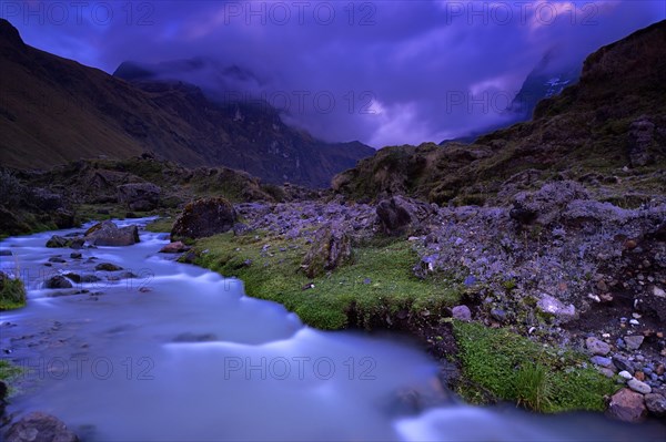 Mountain stream with the peaks of El Altar or Kapak Urku