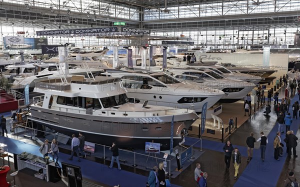 Luxury motor yachts on display in an exhibition hall