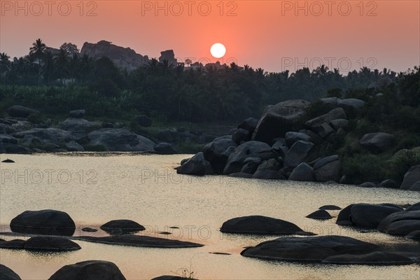 Sunset over Tungabhadra river and a part of the ruins of the former Vijayanagara Empire