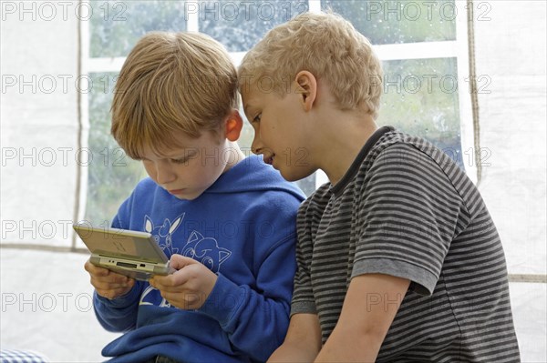 Two boys playing Nintendo