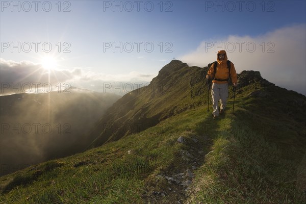 Hiker on the summit of Mt Grosser Galtenberg in the evening light