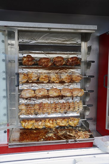 Market stall with a chicken grill and fried chicken