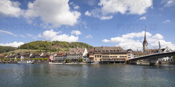 Townscape on the bank of the Rhine River with a boat landing and Burg Hohenklingen Castle