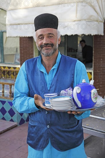 Waiter serving tea in a traditional restaurant