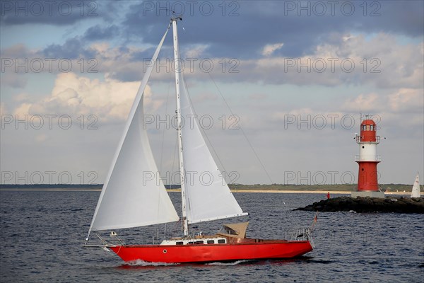 Red Lighthouse and a red sailing boat