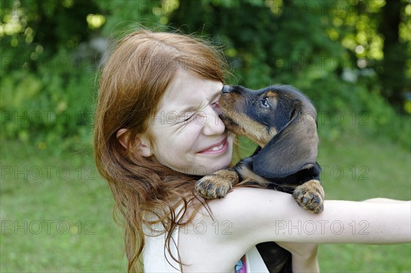 Girl holding a puppy