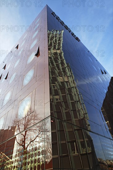 Dancing Towers office building reflected in the facade of the Arcotel Onyx Hotel