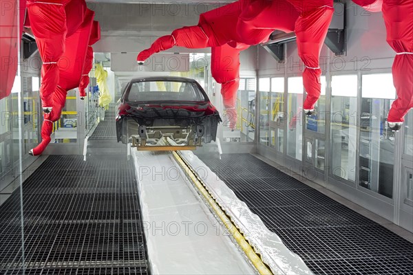 Robots paint a car body in the paint shop at Chrysler's Sterling Heights Assembly Plant