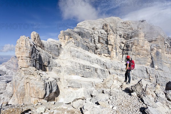 Mountain climber on Punta Anna Mountain while ascending Tofane di Mezzo Mountain along the Via Ferrata Giuseppe di Olivieri climbing route