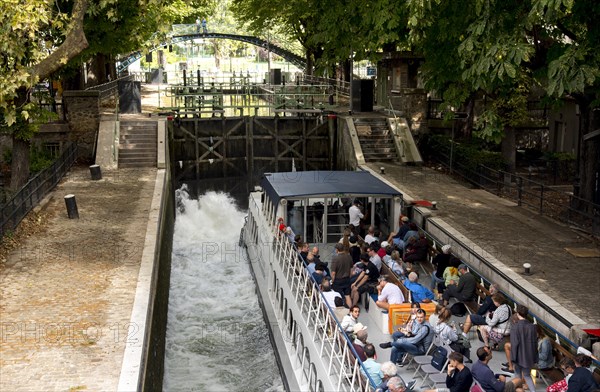 Tourist boat in lock in Canal Saint-Martin