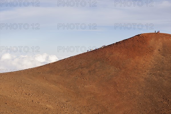 Hikers on the summit of the Mauna Kea volcano