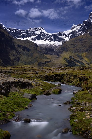 Mountain stream with the peaks of El Altar or Kapak Urku