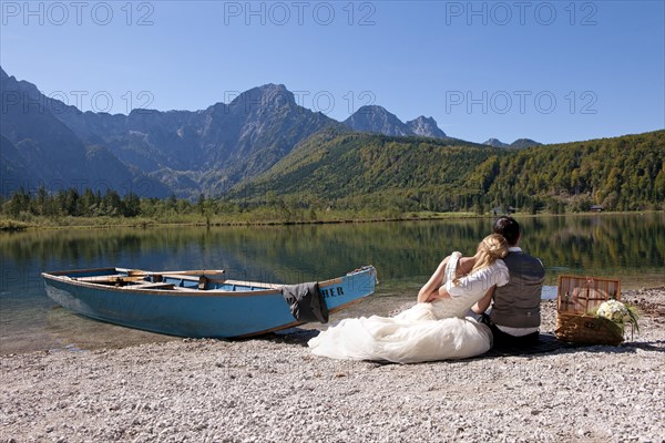 Wedding couple with a boat at Almsee Lake