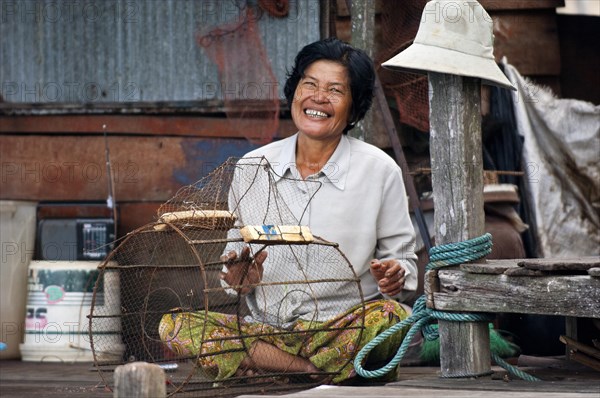 Native woman with a fish trap