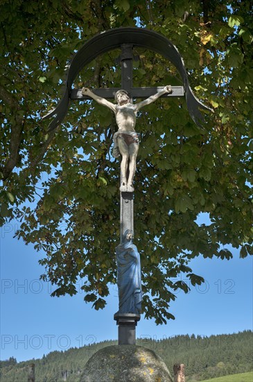 Crucifix under a summer linden (Tilia platyphyllos)