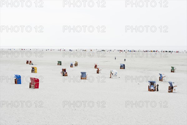 Roofed wicker beach chairs on the beach