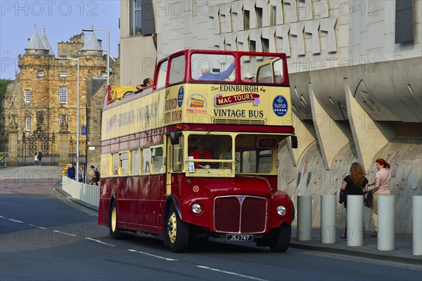 Tourist bus in front of the modern Scottish Parliament and the Holyrood Palace