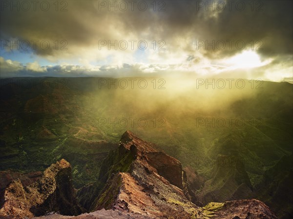 Sunbeams penetrating the dense rain clouds at Waimea Canyon