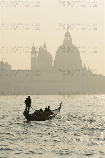 Gondolier on the Grand Canal in front of the Church of Santa Maria della Salute