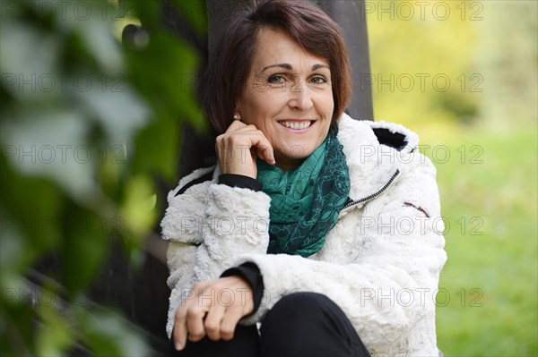 Smiling woman sitting outdoors