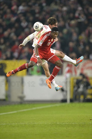 Two players jumping to head a ball