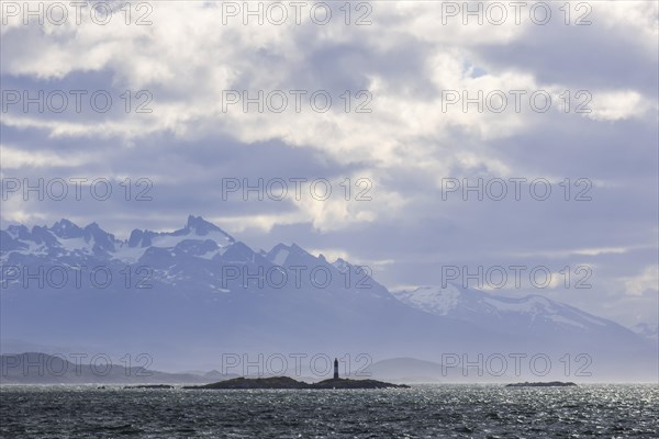 Island with a lighthouse in front of the foothills of the Andes near Ushuaia