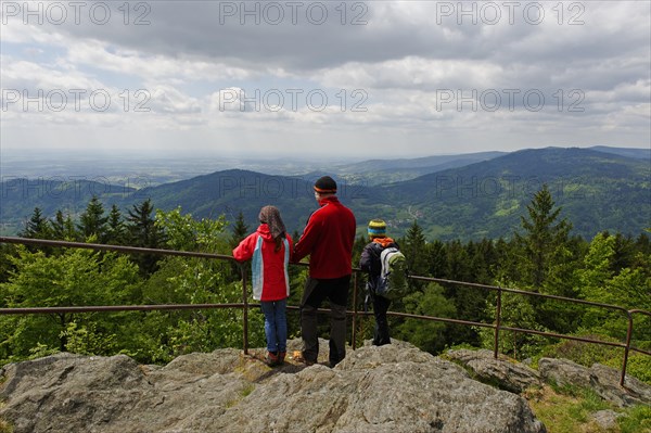 Hikers enjoying the view of the Danube plain from Kreuzfelsen peak