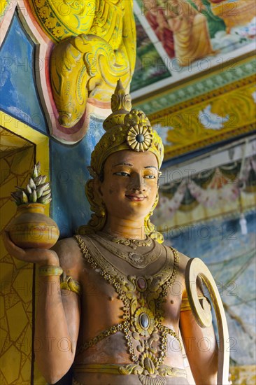 Statue in the old Buddhist temple complex of Sri Pushparama Maha Viharaya