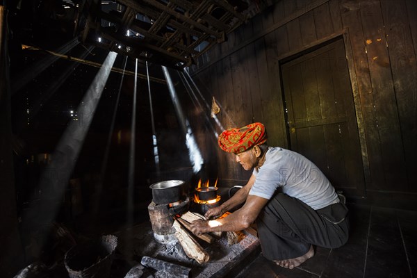 Elderly man at an open fire in the hut