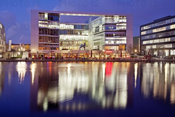 The colourfully lit 'H2 Office' building at dusk