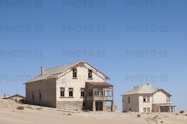 Houses of a former diamond miners settlement that is slowly covered by the sand of the Namib Desert