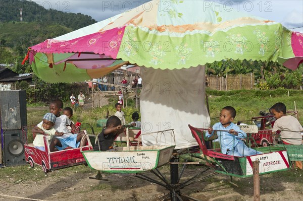 Children riding on a carousel