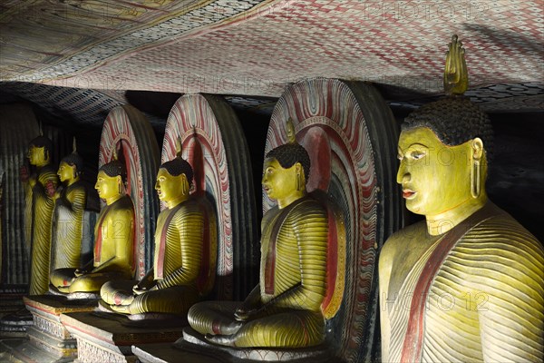 Buddha statues and murals in one of the cave temples of the Golden Temple