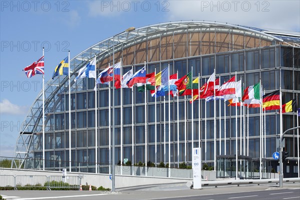 International flags waving in front of European Investment Bank