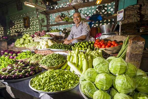 Man selling vegetables at a vegetable market