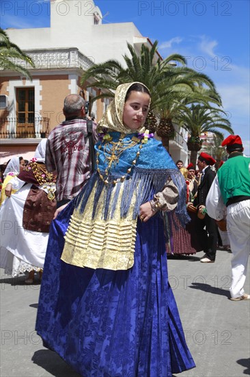 Young woman in traditional costume performing typical dance