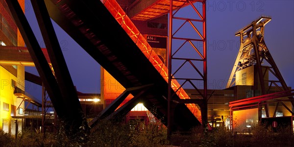 Illuminated gangway to the Ruhr Museum at the Zeche Zollverein Coal Mine Shaft XII with the headframe