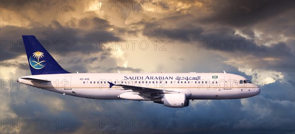 Saudi Arabian Airlines Airbus A320-214 in flight in the evening light