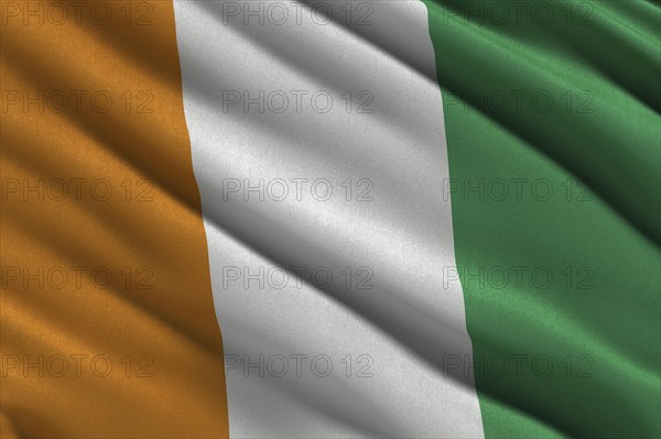 Flag of the Ivory Coast or Republic of Cote d'Ivoire waving in the wind