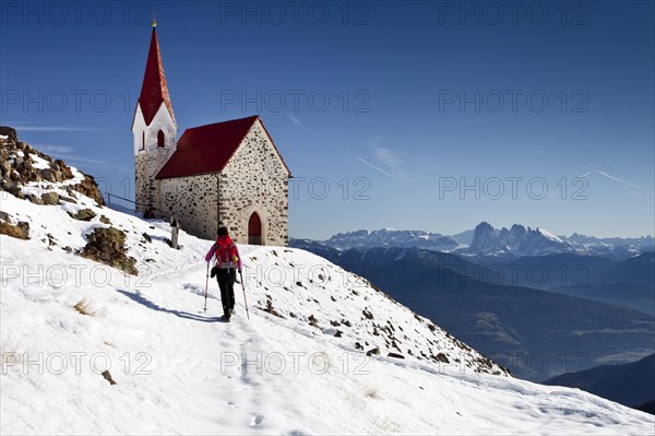 Hiker at the mountain church of Latzfonser Cross