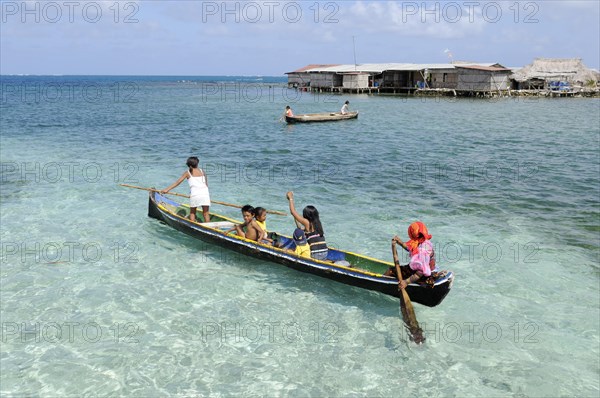 Kuna Indians in a dugout canoe