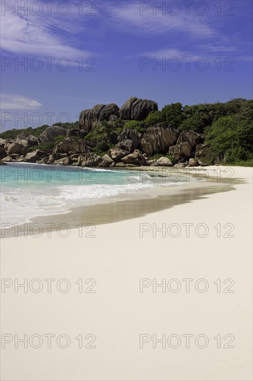 Sandy beach with the rock formations typical for the Seychelles