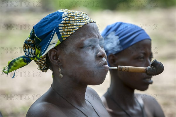 A woman from the Koma people smoking a pipe