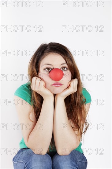 Young woman with clown nose