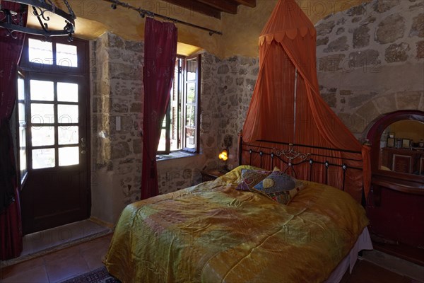 Romantic hotel room with canopy and metal bed