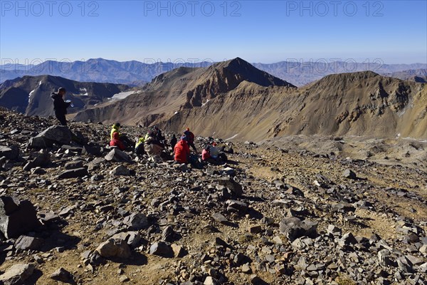 Group of hikers resting on the way to Alam Kuh