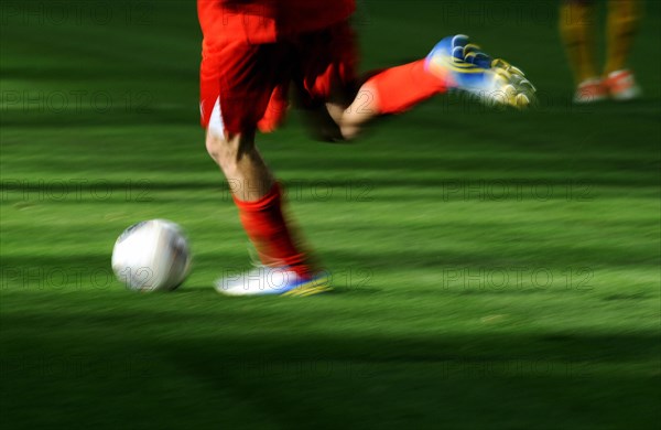 A football player's legs with a football