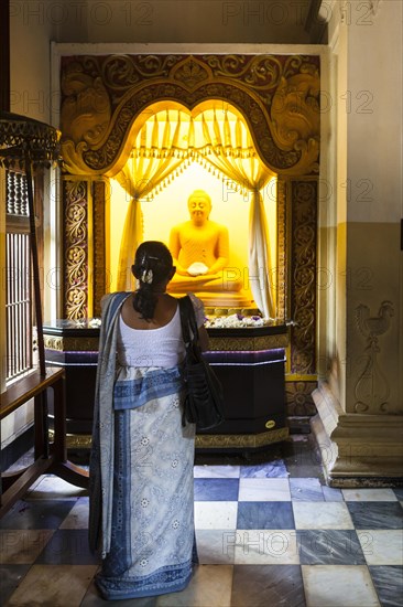 Believers praying in the Temple of the Sacred Tooth Relic