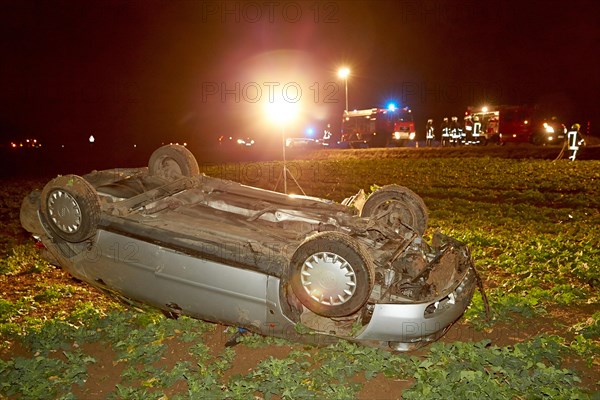 Car which has strayed from the road and rolled over onto its roof